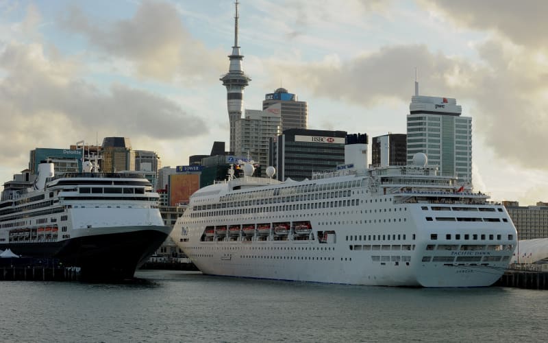 Cruise ships (C) lie tied up at Auckland’s Viaduct Harbour during the 2011 Rugby World Cup on October 14, 2011. Auckland in New Zealand’s North Island has the largest urban area in the country with just over one million people living there.  AFP PHOTO / Greg WOOD (Photo by GREG WOOD / AFP)