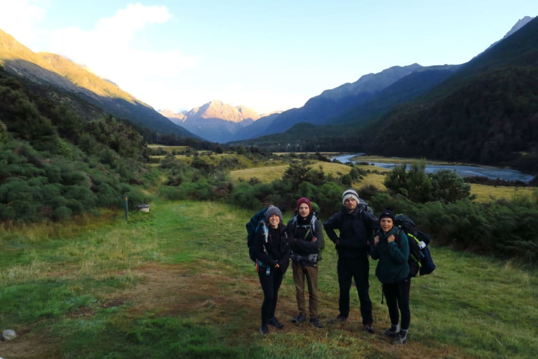 Pauline Dupont and Romain (left) and friends tramping in New Zealand. They emerged from the bush to find the world had turned upside down.