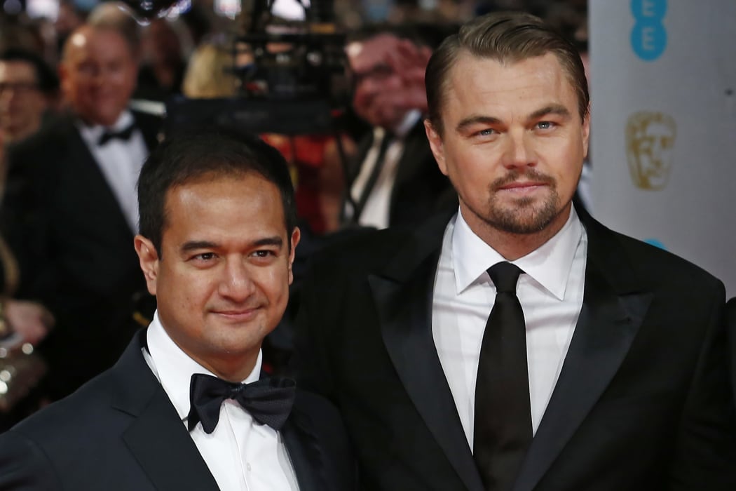 (FILES) In this file photo taken on February 16, 2014, US producers Riza Aziz (L) with US actor Leonardo DiCaprio (R) arrive on the red carpet for the BAFTA British Academy Film Awards at the Royal Opera House in London.