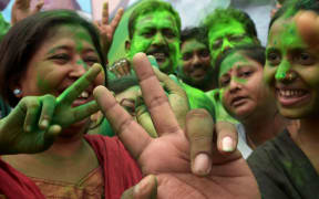 Supporters of Trinamool Congress (TMC) celebrate election results near the house of party supremo and chief minister of eastern West Bengal state.