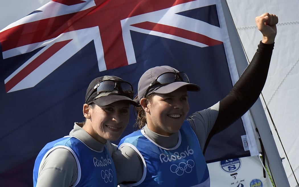 Jo Aleh and Polly Powrie celebrate after medal after the 470 race.