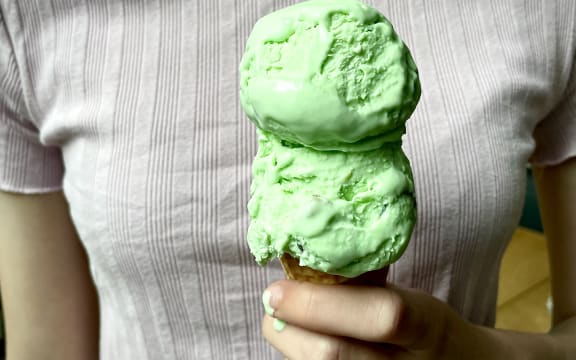 Homemade Goody Gumdrop Ice Cream - a close up of a hand holding a cone topped with two scoops