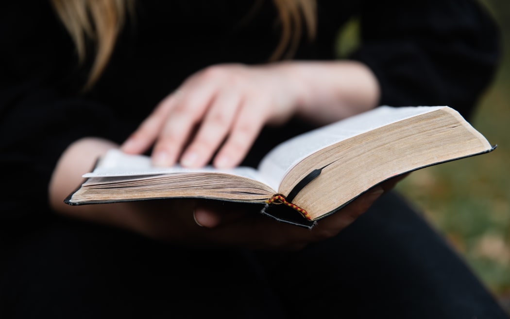 Cassie Dean leafs through the pages of her childihood bible, the New World Translation of the Holy Scriptures.