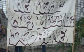 Family of the missing police officer put up a banner pleading for any information.