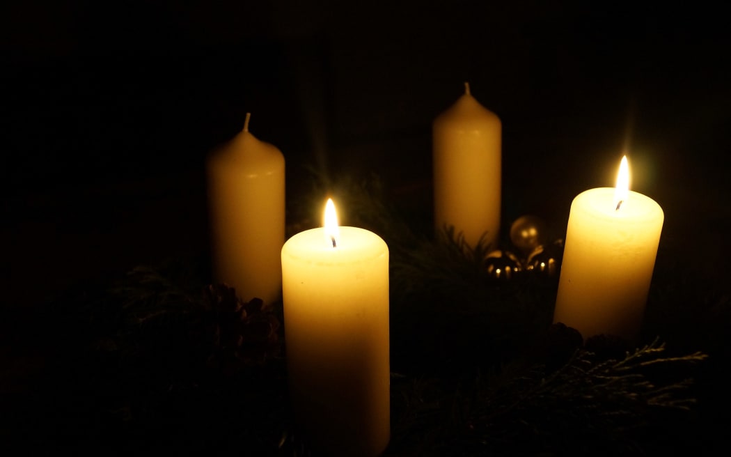 Advent wreath with four candles. Two are lit.