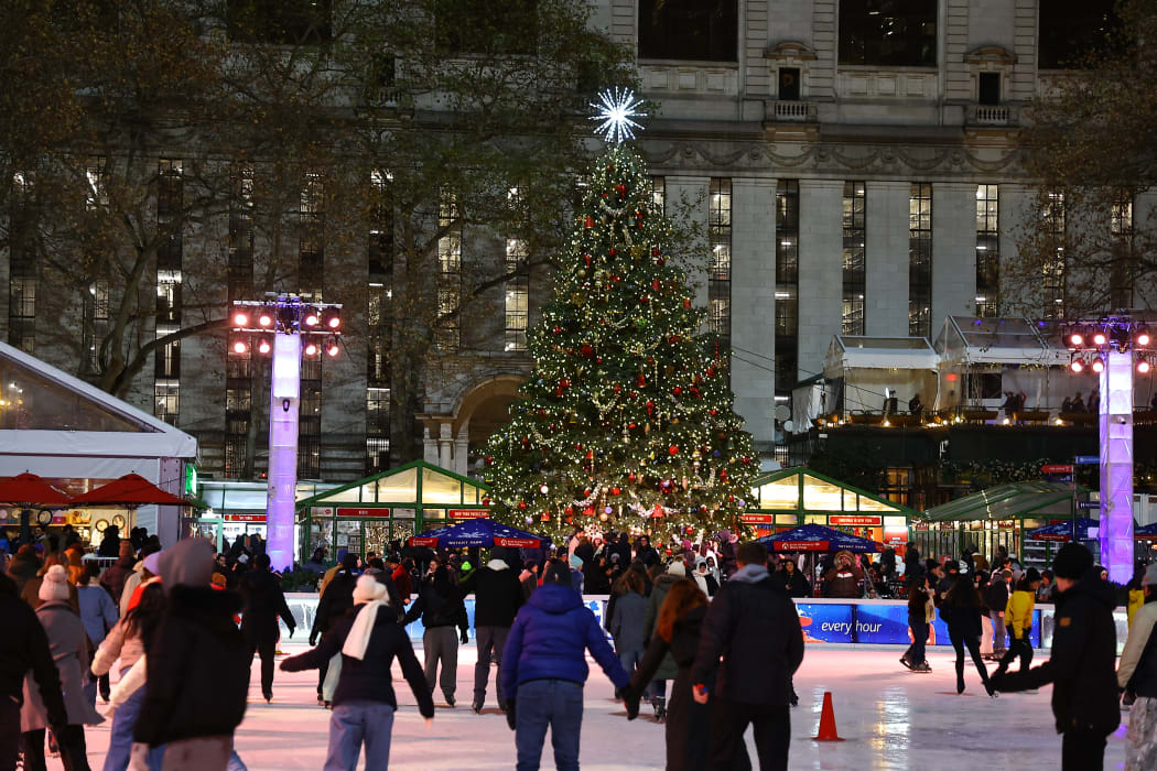 People skate in the Winter Village in Bryant Park in New York, N.Y., on December 12, 2024. The photo is taken as a long exposure. (Photo by Gordon Donovan/NurPhoto) (Photo by Gordon Donovan / NurPhoto / NurPhoto via AFP)