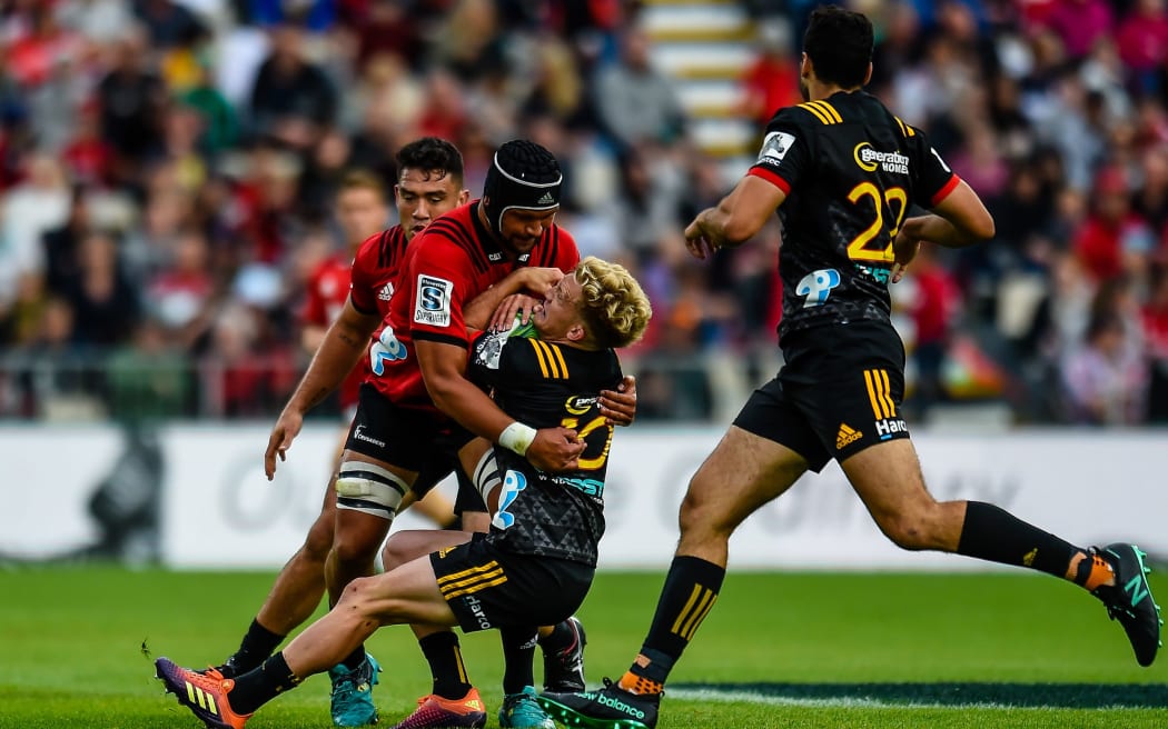 Damian McKenzie is caught in a tackle against the Crusaders.