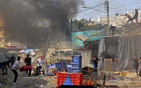 Palestinians clash with Israeli security forces during a raid in the occupied West Bank city of Nablus, on February 22, 2023.