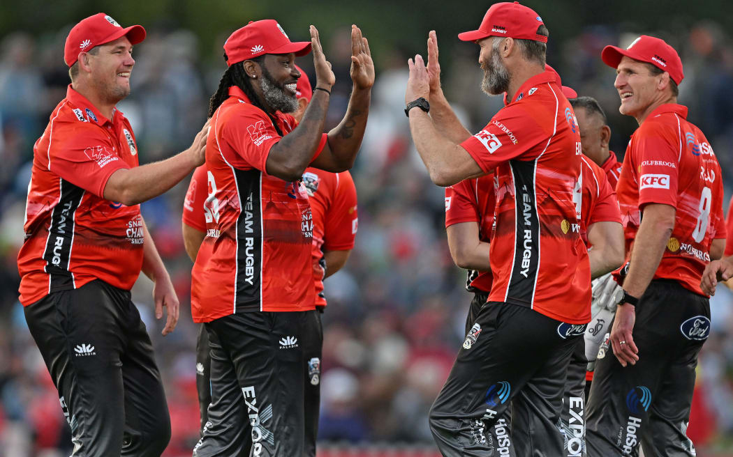 Team Rugby's Chris Gayle celebrates the wicket of Team Cricket's Nathan McCullum with teammates during the T20 Black Clash cricket match between Team Cricket and Team Rugby at Hagley Oval, Christchurch.