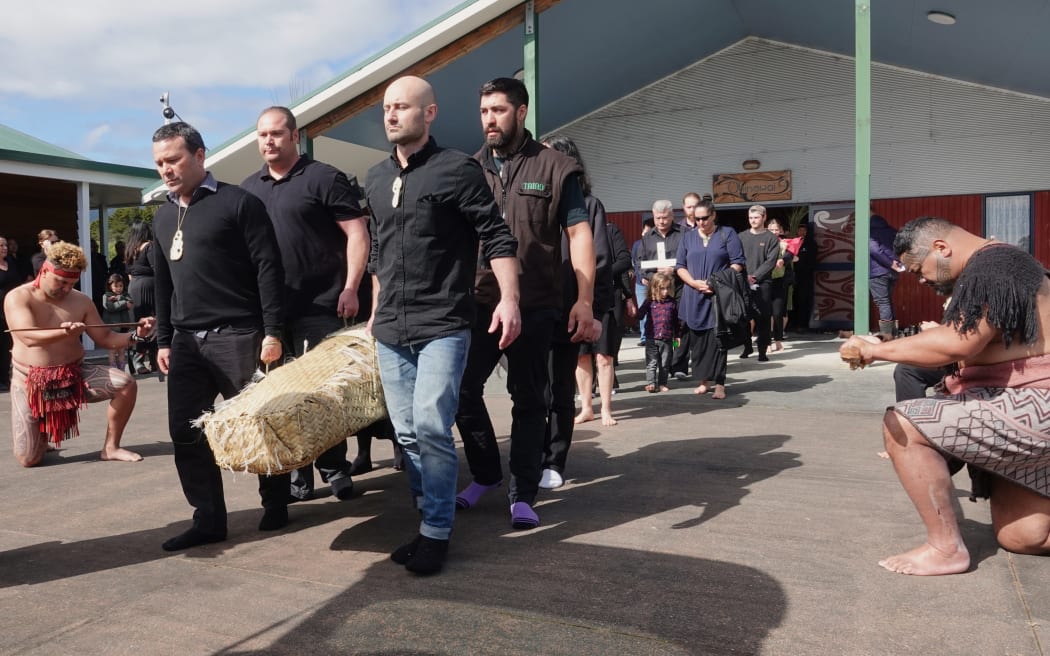 Whānau members carry Sir Patu Hohepa's woven casket to a hearse for his final journey to Okahu cemetery on 25 September, 2023.