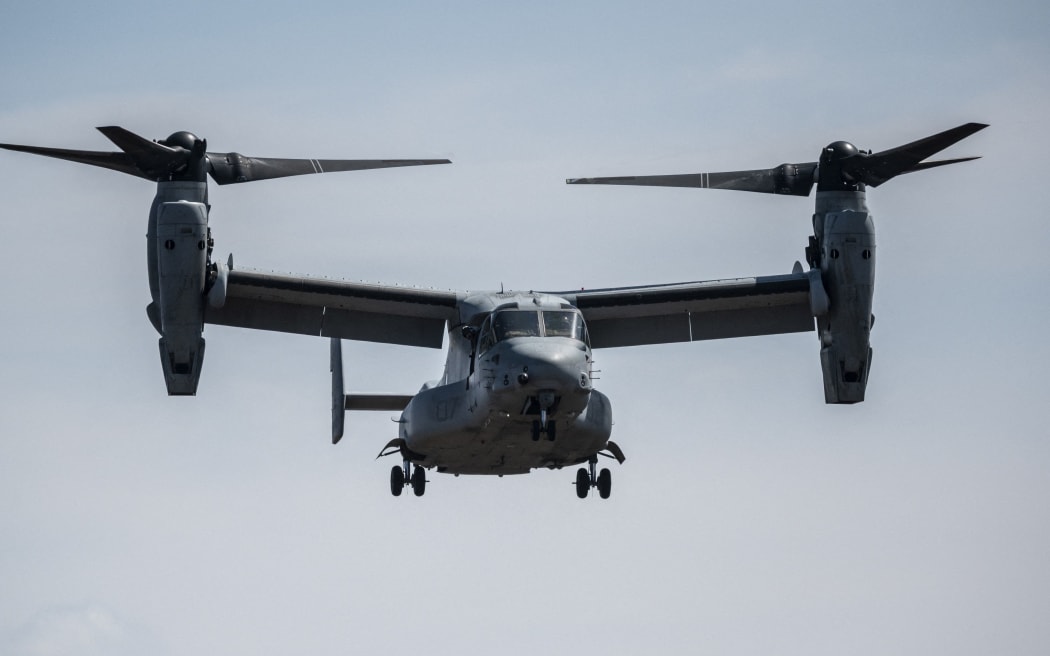 (FILES) This file photo taken on March 15, 2022 shows a US Marine Corps MV-22 Osprey tilt-rotor aircraft landing during a joint exercise with Japanese Self Defense Forces members at the Higashifuji training area in Gotemba, Shizuoka Prefecture. A US Osprey military aircraft with eight people on board crashed on November 29, 2023 off the coast of Japan, the coastguard said. (Photo by Charly TRIBALLEAU / AFP)