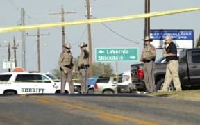 Law enforcement officials gather near First Baptist Church following a deadly mass shooting.