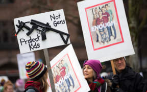 People hold signs during the March for Our Lives rally for Marjory Stoneman Douglas High School students in March 2018 in Seattle, Washington.