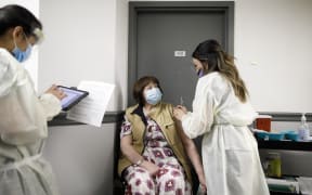 A nurse gives a Covid-19 vaccine to a resident at Humber River Hospital in Toronoto.