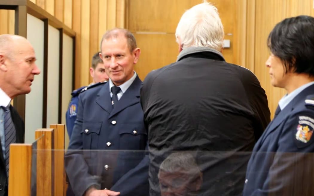 At a court hearing, Alan Rubick refused to face the court despite his lawyer Stephen Ross (left) and the judge telling him to turn around. Photo / NZME