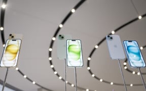 The new Apple iPhone 15, with EU ordered USB-C charger, is displayed amongst other new products during a launch event at Apple Park in Cupertino, California, on September 12, 2023. (Photo by Nic Coury / AFP)