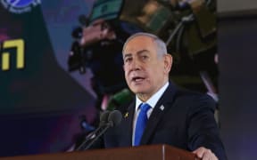 Israel's Prime Minister Benjamin Netanyahu delivers a speech during a ceremony marking the Hebrew calendar anniversary of the Hamas attack on October 7 last year that sparked the ongoing war in Gaza, at the Mount Herzl military cemetery in Jerusalem on October 27, 2024. (Photo by GIL COHEN-MAGEN / AFP)
