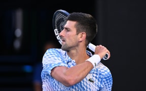Serbia's Novak Djokovic serves against USA's Tommy Paul during their men's singles semi-final match on day twelve of the Australian Open tennis tournament in Melbourne on January 27, 2023. (Photo by WILLIAM WEST / AFP) / -- IMAGE RESTRICTED TO EDITORIAL USE - STRICTLY NO COMMERCIAL USE --