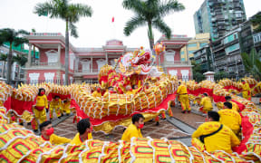 People perform a dragon dance to celebrate the Chinese Lunar New Year in Macao, south China, 1 February 2022.