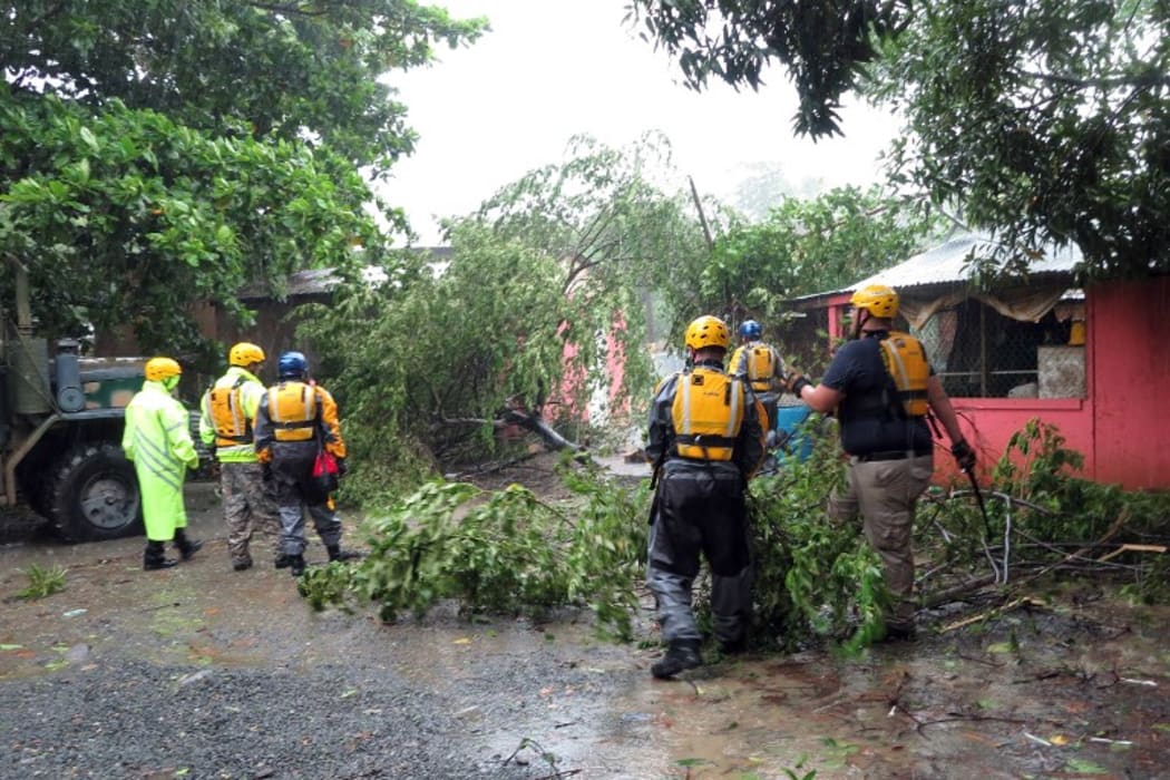 Search and rescue crew members clears a fallen tree during a search mission as hurricane Irma hits Puerto Rico in Fajardo.