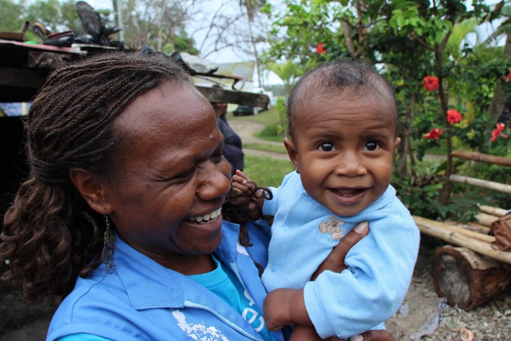 UNICEF's Rebecca Olul, (left)