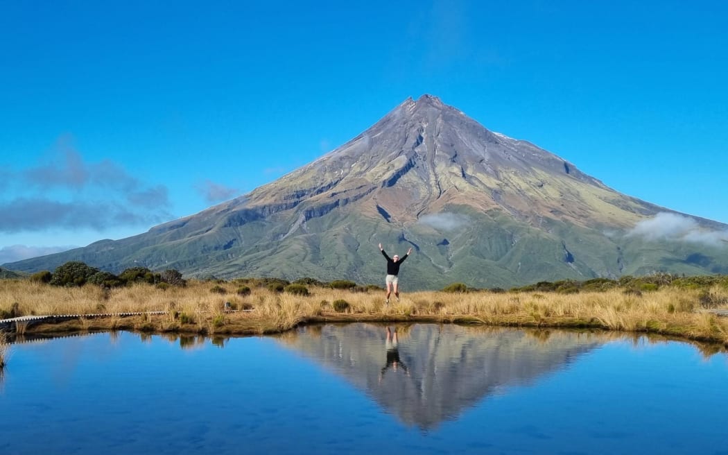A tourist posing for an Instagram shot at the turns.