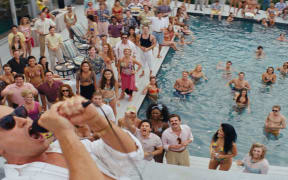 A scene from the movie Wolf of Wall Street starring Leonardo DiCaprio, which detailed the excessive celebrations and criminal activities of a financial trader l in the 1980s and 1990s.