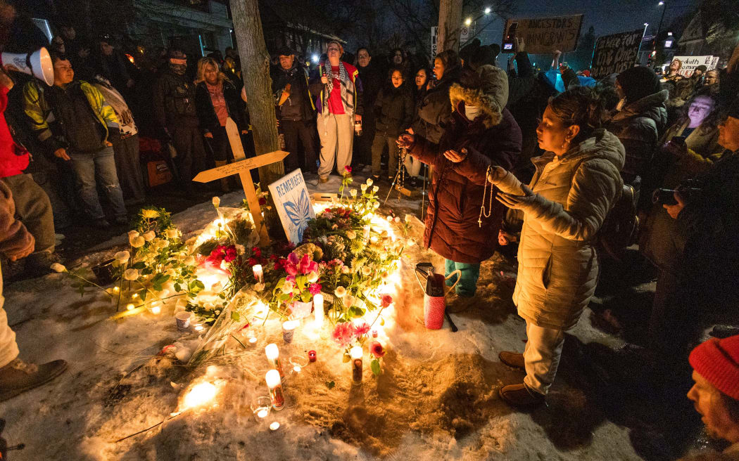 People gather for a vigil and protest for Renee Nicole Good near the intersection of East 34th Street and Portland Avenue in Minneapolis, Minnesota, on January 7, 2026. Renee Nicole Good, 37 years old, is killed by an ICE officer during a confrontation on the morning of January 7 during federal law enforcement operations happening in south Minneapolis. (Photo by Steven Garcia/NurPhoto) (Photo by Steven Garcia / NurPhoto via AFP)