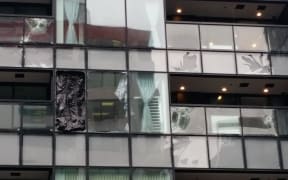 Building on Albert St with windows smashed from storm.