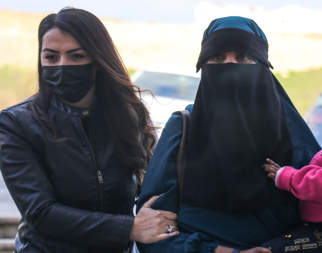 A 26-year-old New Zealand citizen, right, and two children were taken to court at Hatay under security measures. Turkye's Ministry of National Defence said they tried to enter from Syria illegally.