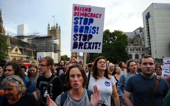 Anti-Brexit demonstrators march from Britain's Houses of Parliament to Downing Street in protest at Prime Minister Boris Johnson's announcement that Parliament will be suspended for more than a month.