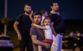 People leave Ataturk Airport after  explosions outside the arrivals hall.
