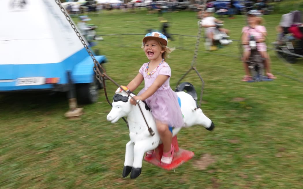 Two-year-old Indi Dunbar, from Kerikeri, shows her delight on the merry-go-round.