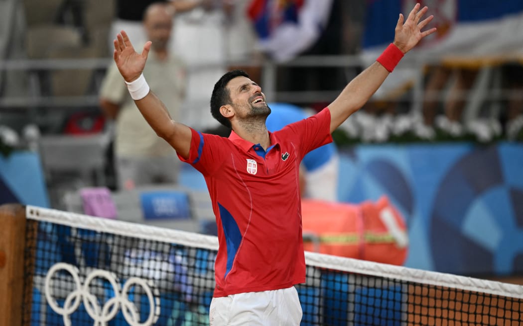 Serbia's Novak Djokovic celebrates beating Italy's Lorenzo Musetti during their men's singles semi-final tennis match on Court Philippe-Chatrier at the Roland-Garros Stadium during the Paris 2024 Olympic Games, in Paris on August 2, 2024. (Photo by CARL DE SOUZA / AFP)