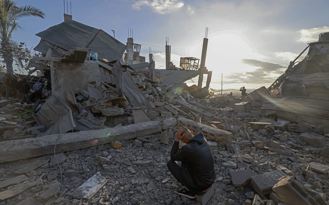 A man sits amid the debris of destroyed houses in the aftermath of Israeli bombardment in Rafah in the southern Gaza Strip on February 22, 2024, amid continuing battles between Israel and the Palestinian militant group Hamas. (Photo by MOHAMMED ABED / AFP)