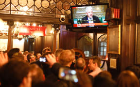 Pubgoers watch a television screen in Whitehall as John Bercow, Speaker of the House declares that Prime Minister Theresa May's Brexit deal was defeated by 149 votes in an historic parliamentary vote on March 12, 2019.