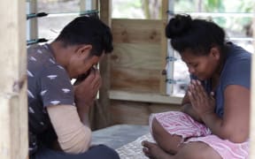 Paulo and Fa'osa pray for their three children who died after contracting measles.
