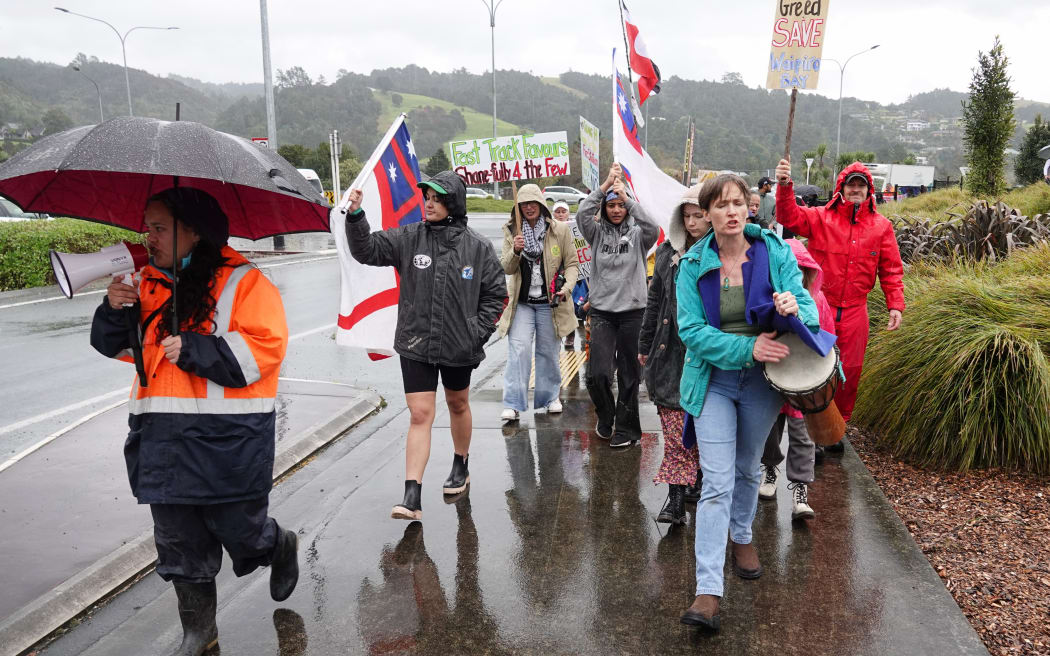 Protesters against the Waipiro Bay Marina proposal march on Western Hills Drive in Whangārei.