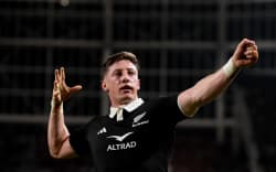 Cam Roigard of the All Blacks celebrates scoring a try.