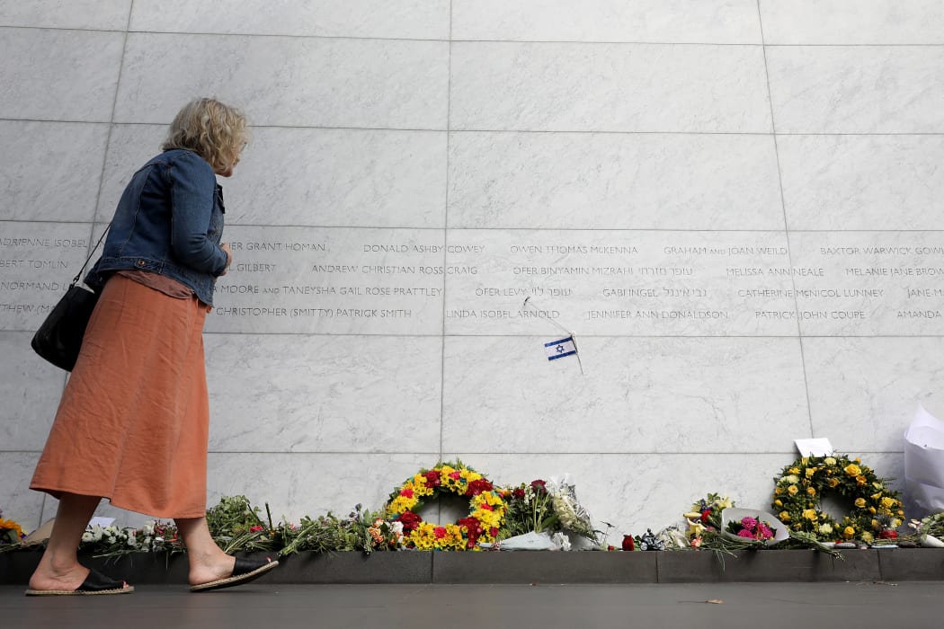 A member of the public looks at the names of the 185 people who died in the 2011 earthquake, during the national memorial service for its 10th anniversary in Christchurch on February 22, 2021.
