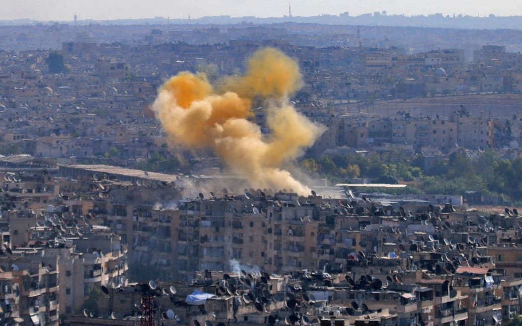 Smoke from reported opposition fire rises in a designated humanitarian corridor in eastern Aleppo.