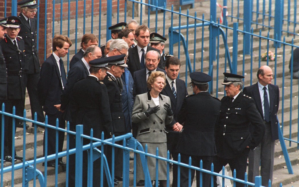Britain's Prime Minister Margaret Thatcher is shown the enclosure at Hillsborough Stadium in Sheffield on 16 April, 1989, where a human crush ultimately led to 97 people dying.