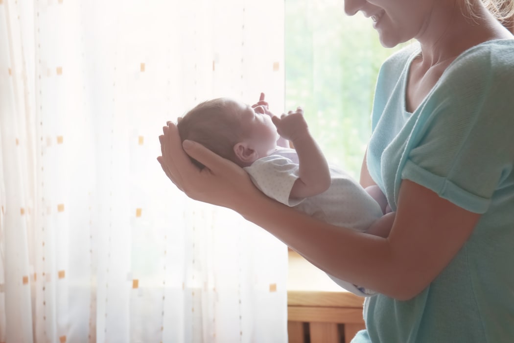 Woman holding newborn.