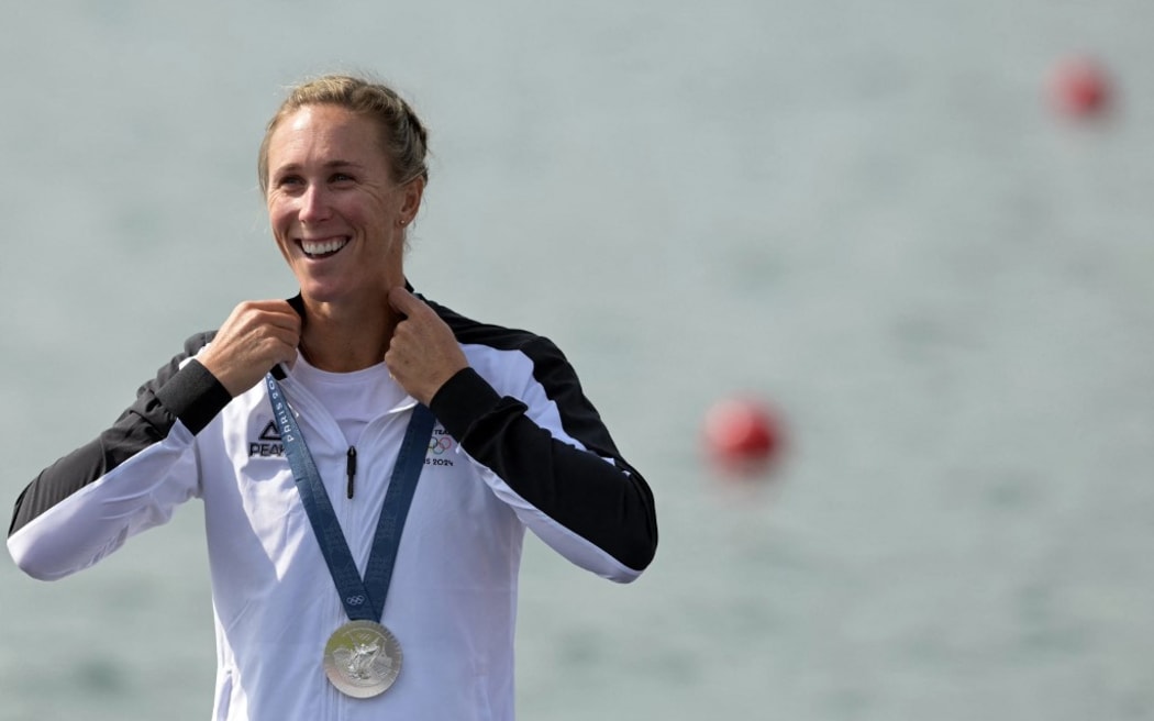 New Zealand's silver medallist Emma Twigg celebrates on the podium during the medal ceremony after the women's single sculls final of the rowing competition at Vaires-sur-Marne Nautical Centre in Vaires-sur-Marne during the Paris 2024 Olympic Games on August 3, 2024. (Photo by Bertrand GUAY / AFP)