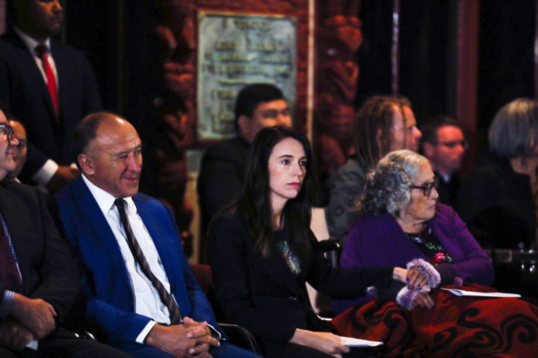 Jacinda Ardern and Titewhai Harawira hold hands on the verandah of The Whare Runanga.