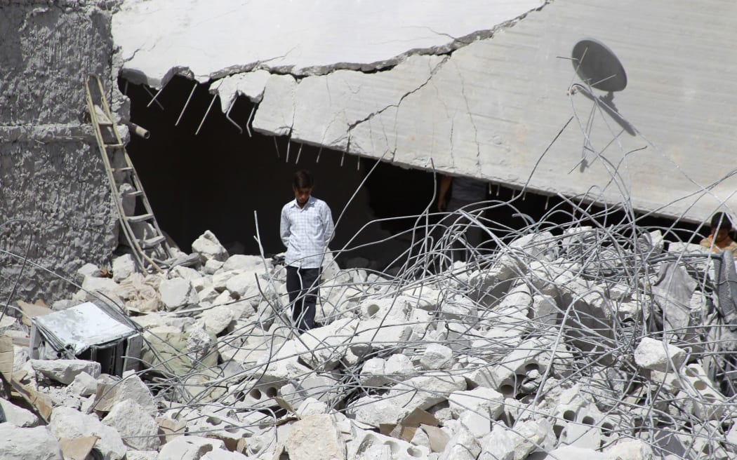 Buildings damaged in what activists say was one of Tuesday's US air strikes at Kfredrian in Idlib province, Syria.