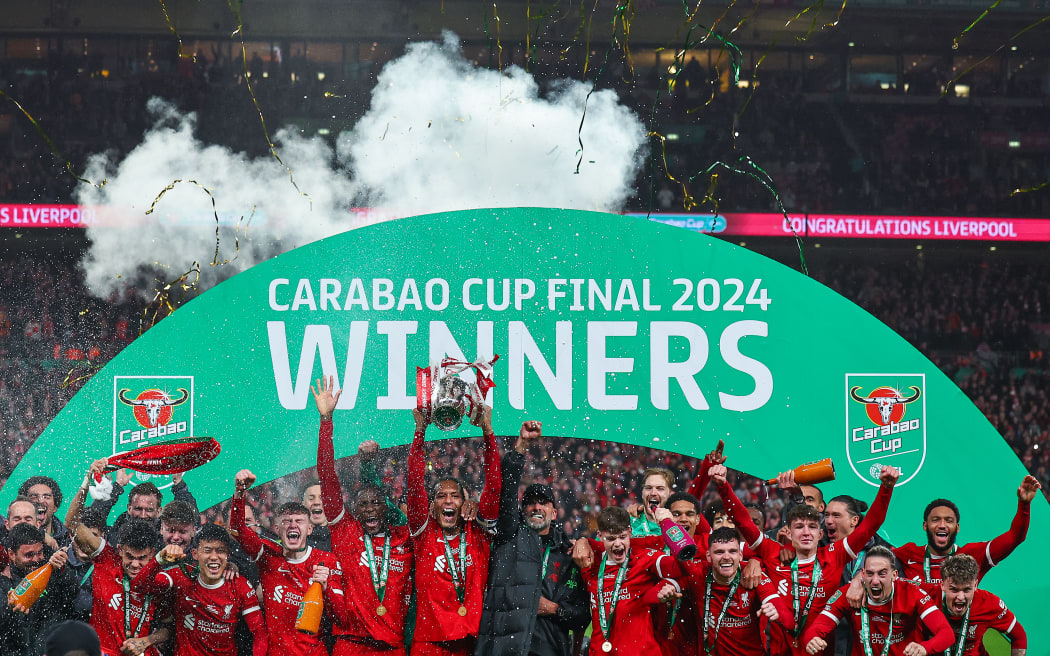 Virgil van Dijk of Liverpool lifts the Carabao Cup trophy.