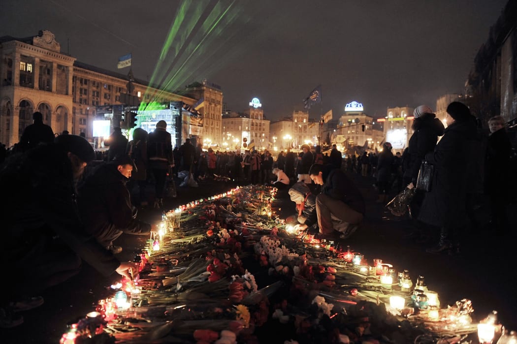 Candles lit in Kiev's Independence Square to honour those killed in protest action.