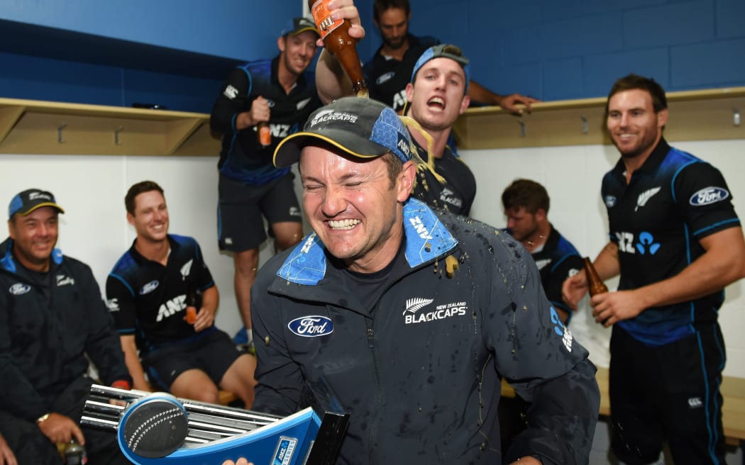 The Black Caps and coach Mike Hesson celebrate their Chappell-Hadlee series win.