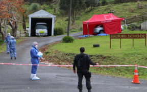 Police at Hauturu School, where the shooting victims ended up.